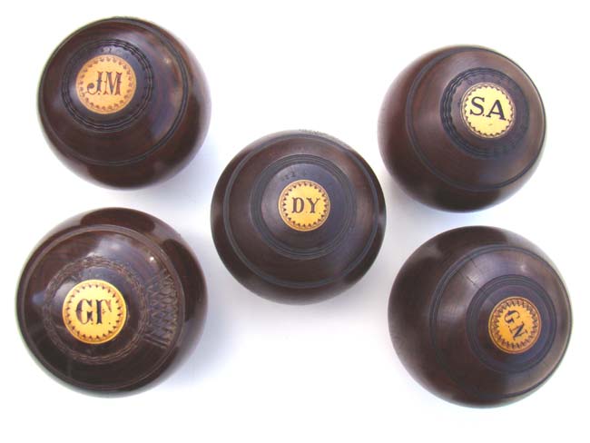 A collection of five Antique English Lignum Vitae Lawn Bowling Balls circa 1890-1920